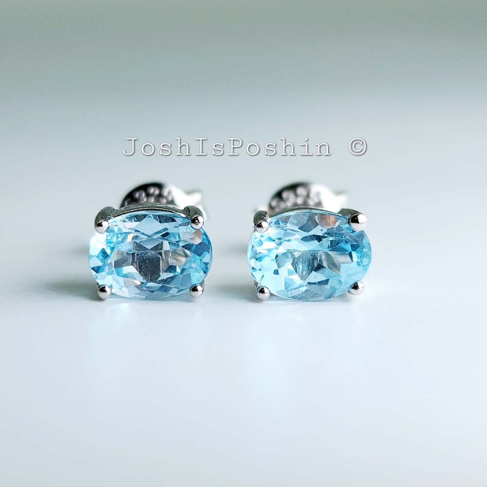 Natural oval sky blue topaz stud earrings in sterling silver